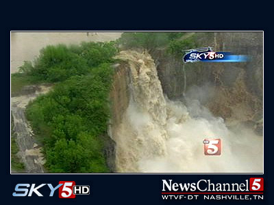 River bursting through a rock wall to create a waterfall.